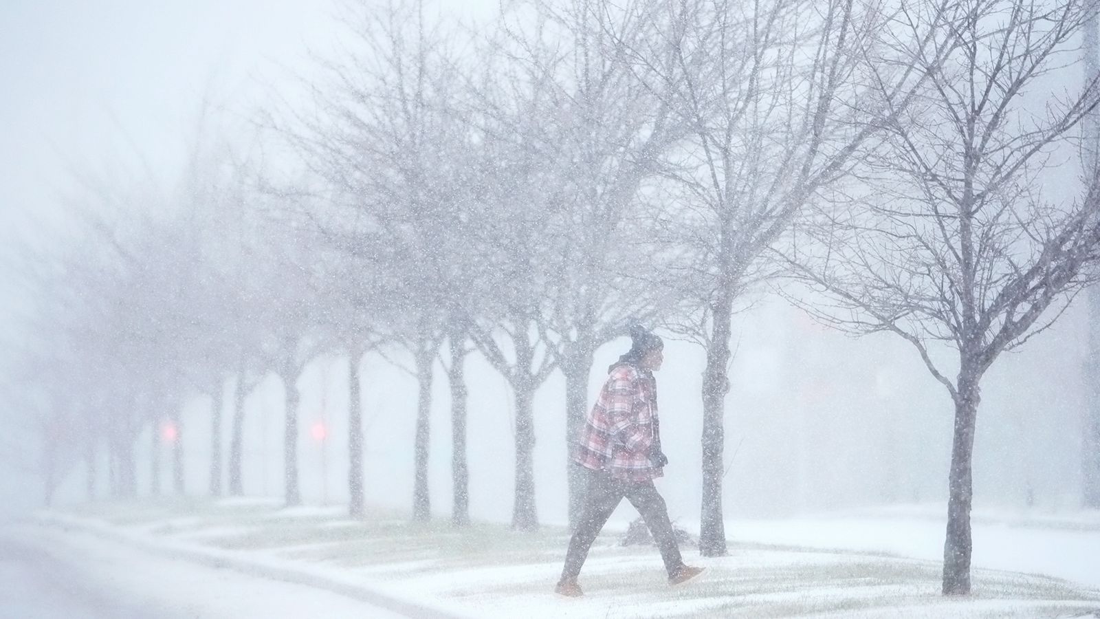 Photo of a person walking in the snow in St. Louis, MO.